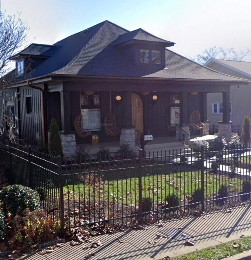 A black ornamental metal fence enclosing the front yard of a home, installed by America's Fencing in Nashville, TN.