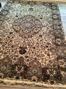 An ornate area rug with intricate patterns, showcasing the type of rugs handled by Carpet & Rug Cleaning in Mount Pleasant, SC.