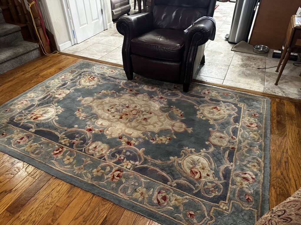A beautifully cleaned ornate area rug on a hardwood floor, showcasing rug cleaning expertise from Heaven's Best Carpet Cleaning San Diego CA.