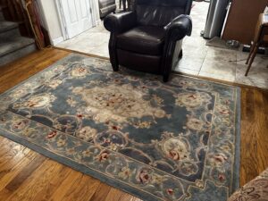 A beautifully cleaned ornate area rug on a hardwood floor, showcasing rug cleaning expertise from Heaven's Best Carpet Cleaning San Diego CA.