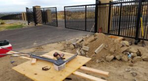 An ornate black gate installation in progress with tools and materials by Integrity Gates and Fencing in Yakima, WA