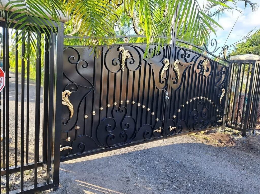 An ornate black and gold wrought iron gate providing elegant security by A Master Work Corp. in Hialeah, FL.