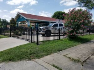 An ornate black metal fence and gate installed for a residential home by Serrato's Fence & Welding in San Antonio, TX.