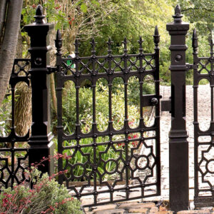 An ornate black metal garden gate with intricate designs, installed by Ozark Fence in Lakewood, CO.