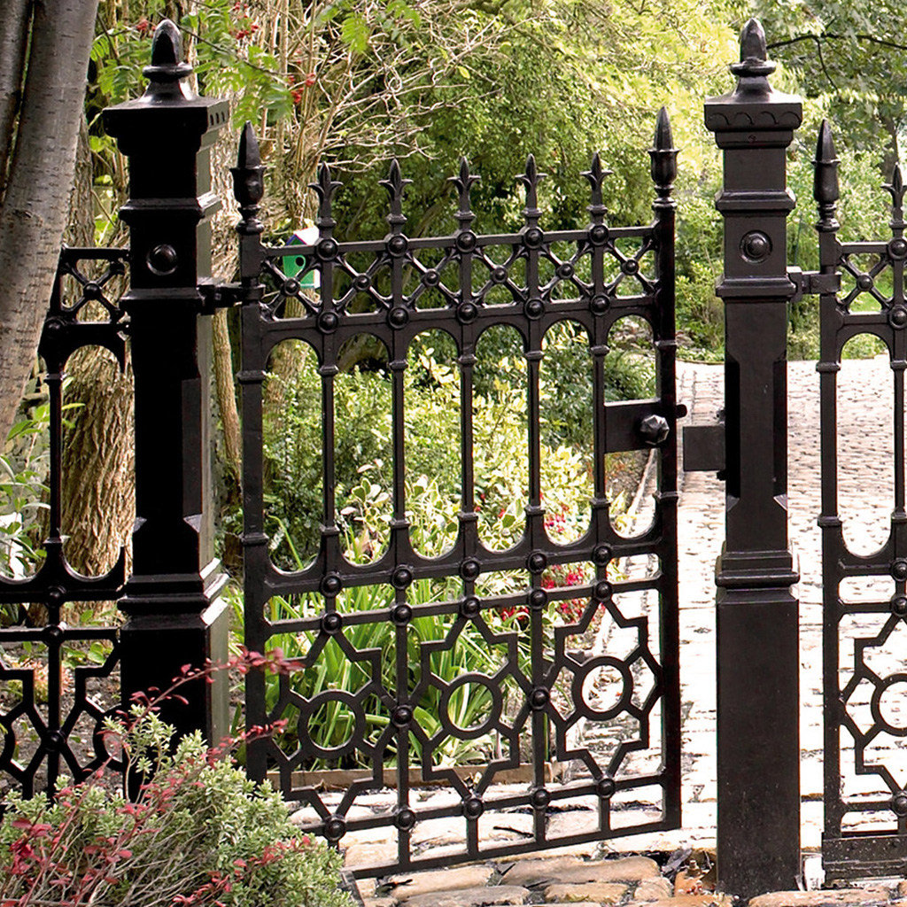 An ornate black metal garden gate with intricate designs, installed by Ozark Fence in Lakewood, CO.