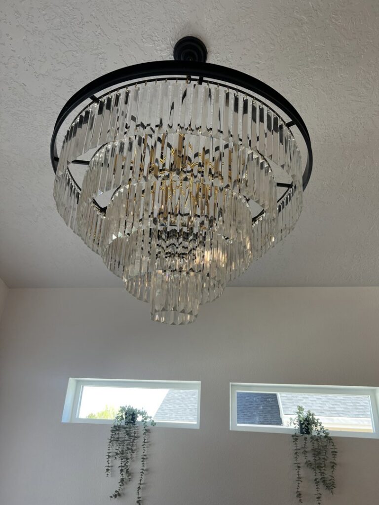 A beautiful, ornate chandelier installed on a ceiling, showcasing lighting fixture services by Veritas Electric in Yalaha, FL.