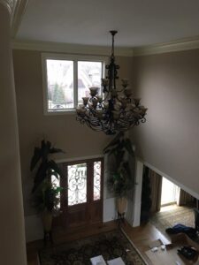 A grand ornate chandelier expertly installed in a high-ceiling entryway by TGR Electric LLC in Carmel, IN.