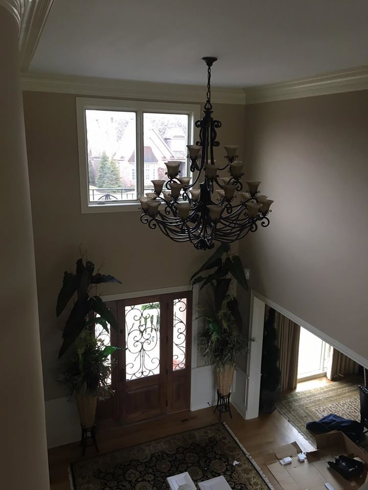A grand ornate chandelier expertly installed in a high-ceiling entryway by TGR Electric LLC in Carmel, IN.