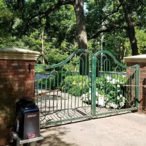 Ornate green automated gate with brick pillars installed by Gate Options in West Chicago, IL