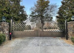 An ornate custom metal double entry gate installed by Smithfield Fence in Crowder, MS.