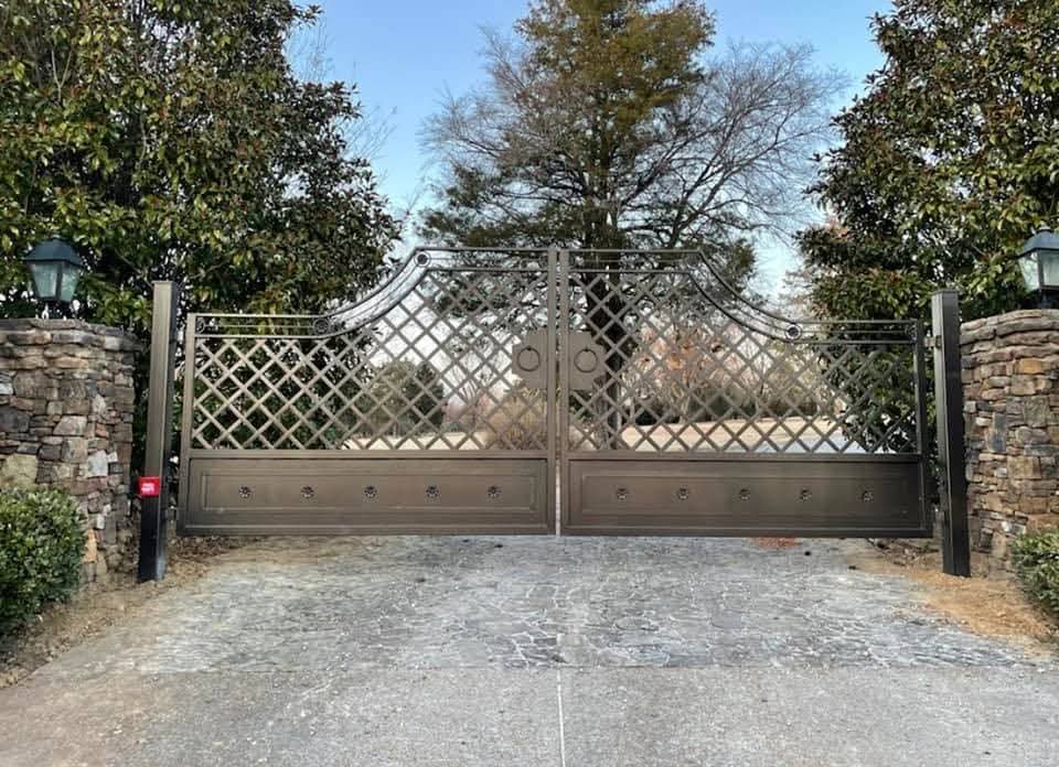 An ornate custom metal double entry gate installed by Smithfield Fence in Crowder, MS.
