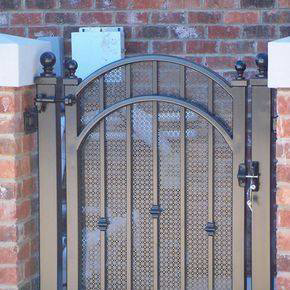 An ornate custom metal gate with an arched design installed by Rivas G Fidelito in Cerritos, CA.