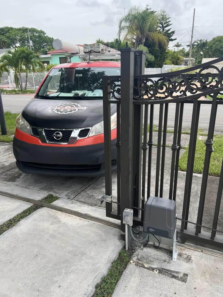 An ornate black sliding gate with a new gate motor installation by Motor & Fence Solutions in Miami, FL.