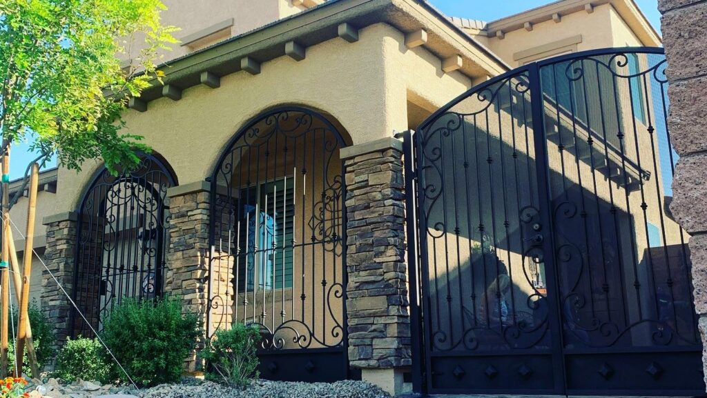 An ornate wrought iron entry gate and matching window security bars installed by Custom Customs Inc. in Henderson, NV