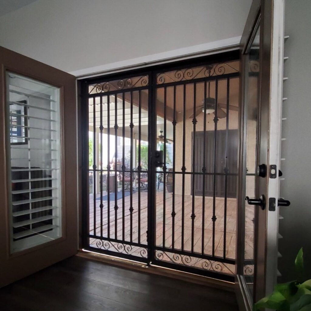 Ornate wrought iron security doors leading to a patio, installed by Custom Customs Inc. in Henderson, NV