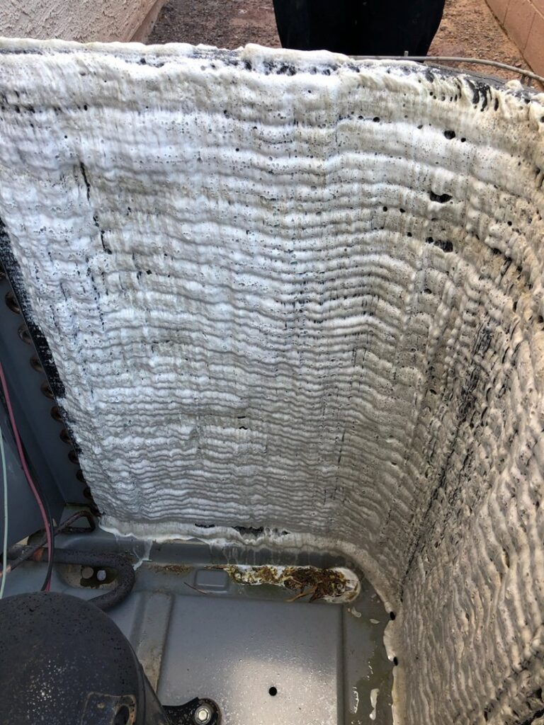 An outdoor air conditioning coil being cleaned with foam during maintenance by Ace A/C & Heating in Henderson, NV.