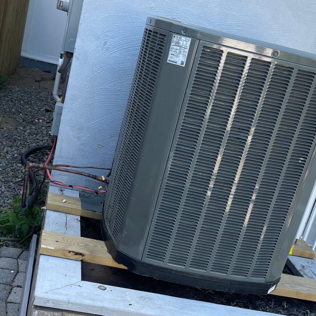 An outdoor air conditioning condenser unit being installed or serviced by GT Mechanical Services in Baltimore, MD