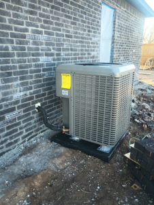 New outdoor AC condenser unit installed at a construction site by Air Prime OKC in Oklahoma City, OK