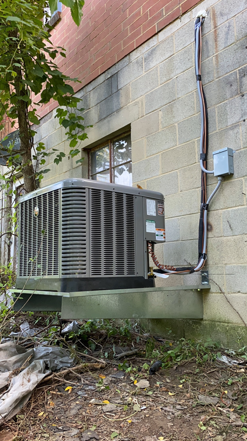 An outdoor air conditioning condenser unit professionally installed by Vico&Son HVAC Services and Sheet Metal LLC in Beltsville, MD.