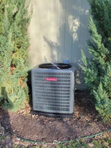 A Goodman outdoor AC condenser unit installed by ESR Heating, Cooling and Refrigeration in Raymore, MO.