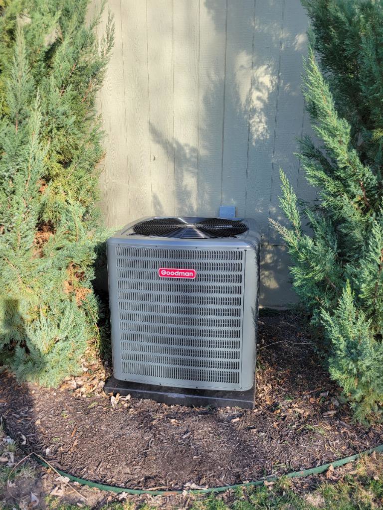 A Goodman outdoor AC condenser unit installed by ESR Heating, Cooling and Refrigeration in Raymore, MO.