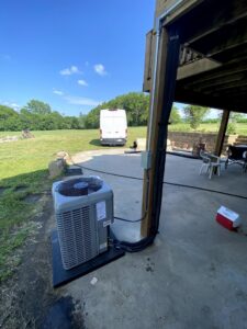 An outdoor AC condenser unit installed next to a home by Millard Heating & Cooling in Elkhorn, NE.