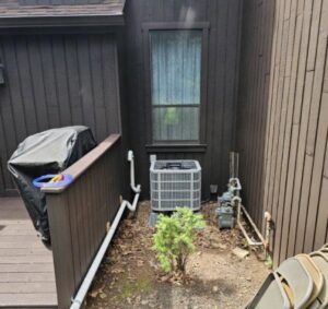 Outdoor air conditioning condenser unit installed next to a residential building by NewEra Mechanical LLC in New Britain, CT