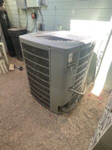An outdoor AC condenser unit, a common component serviced by Larson Air Conditioning in Scottsdale, AZ