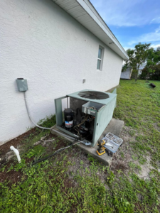 An outdoor AC condenser unit undergoing repair with its panel removed by AC All Stars AC contractor in Fort Lauderdale, FL.