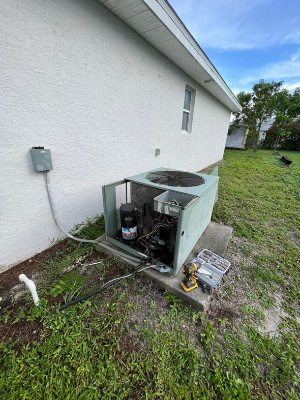 An outdoor AC condenser unit undergoing repair with its panel removed by AC All Stars AC contractor in Fort Lauderdale, FL.