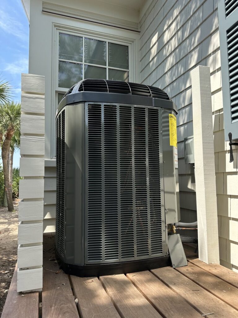 An outdoor AC condenser unit installed at a residential property by AC Heating and Air Conditioning Services in Charleston, SC.