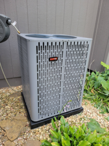 An outdoor RunTru AC condenser unit installed by ESR Heating, Cooling and Refrigeration in Raymore, MO.