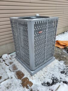 A RunTru outdoor AC condenser unit installed in winter by ESR Heating, Cooling and Refrigeration in Raymore, MO.