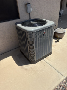 An outdoor AC condenser unit installed by Weather Masters, Inc. in Mesa, AZ.