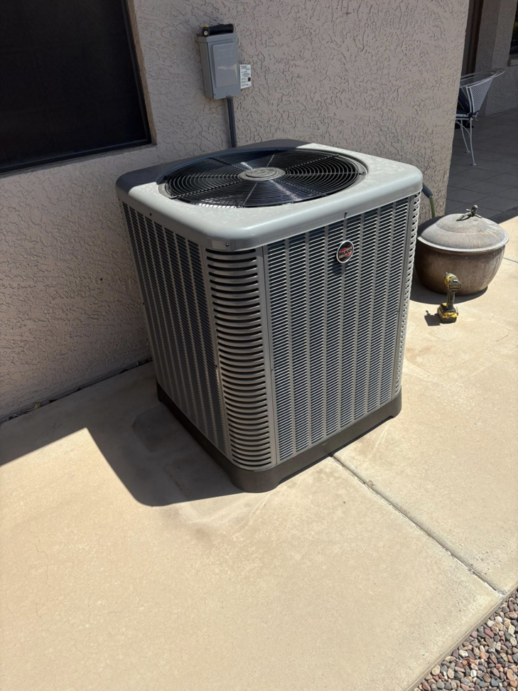 An outdoor AC condenser unit installed by Weather Masters, Inc. in Mesa, AZ.
