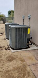 Two outdoor air conditioning condenser units installed by Brisk Air Inc in Phoenix, AZ.
