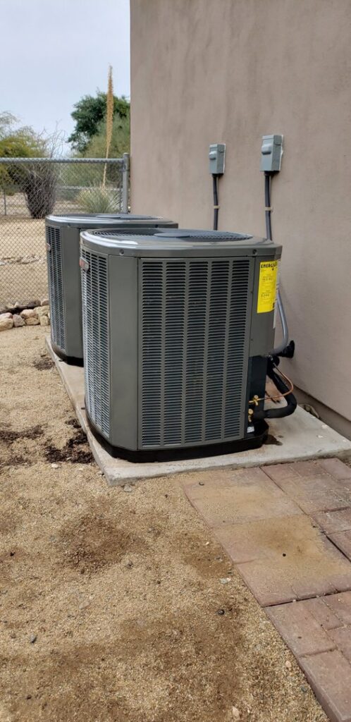 Two outdoor air conditioning condenser units installed by Brisk Air Inc in Phoenix, AZ.