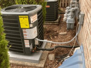 Two outdoor air conditioning condenser units installed or serviced by Evergreen Services in Warwick, RI.