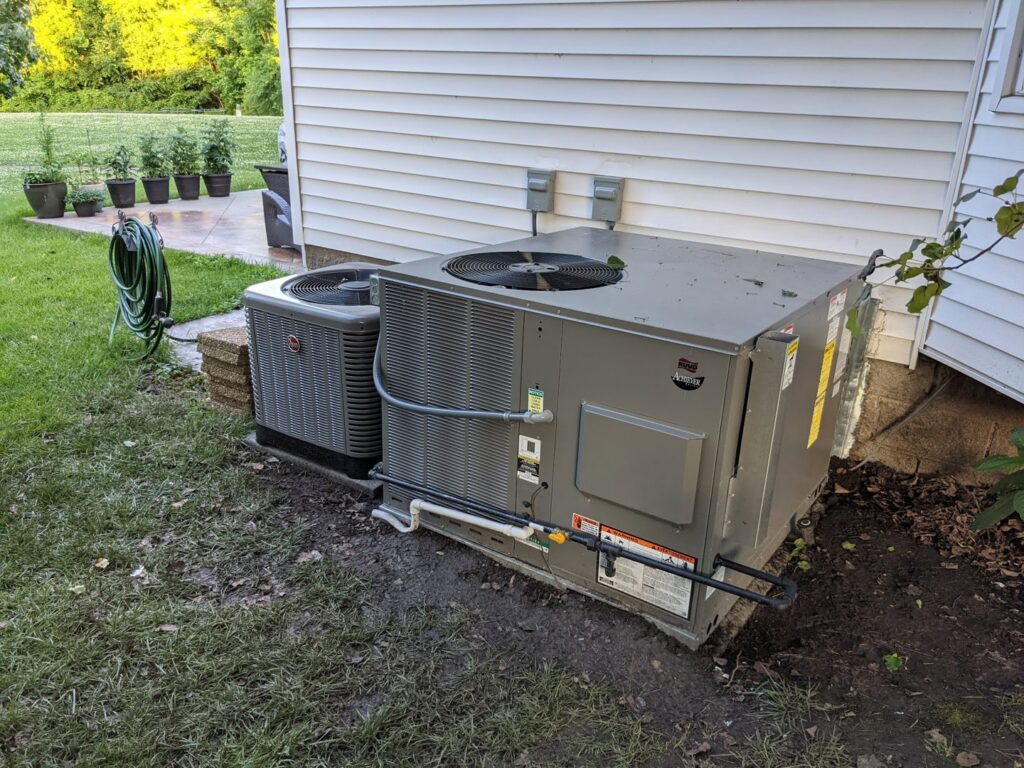 Two outdoor air conditioning condenser units installed next to a residential home by Morse Brothers Heating and Air in Franklin, TN.