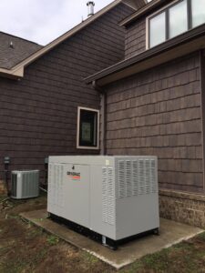An outdoor air conditioning unit installed next to a Generac whole-home generator by Douglas Cooling & Heating in Pelham, AL.