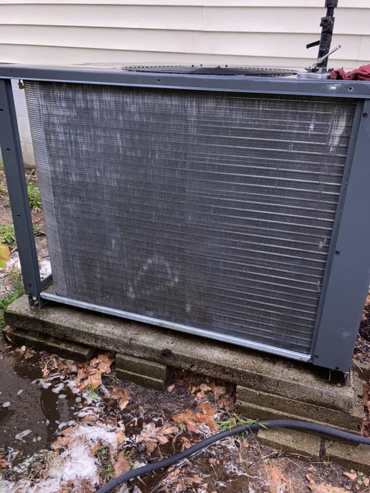 An outdoor AC unit being cleaned during a service appointment by Your Angel Heating And Cooling LLC in Cary, NC.