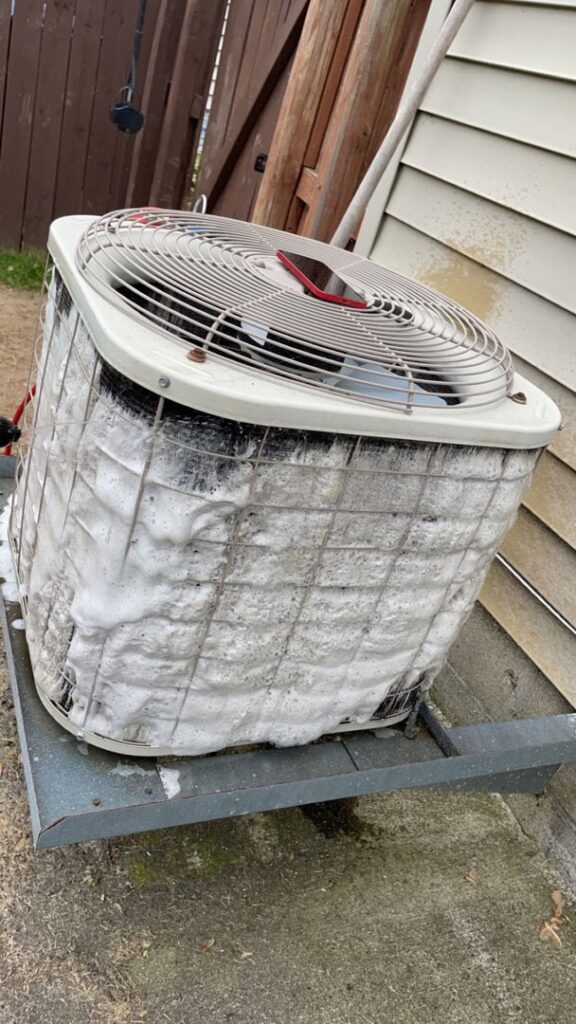 An outdoor AC unit being cleaned with foam during maintenance by Buckeye Mechanical Construction in Columbus, OH.