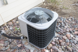 An outdoor air conditioning unit (condenser) for a home, serviced by APM Heating and Air Conditioning in Columbia, MO.