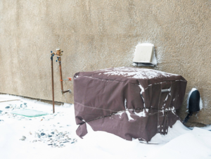 An outdoor air conditioning unit covered for winter protection by Above & Beyond Heating and Air Conditioning in Iowa City, IA.