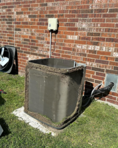 An outdoor AC unit with debris on its coils, ready for cleaning by CLM Mechanical in Dallas, TX
