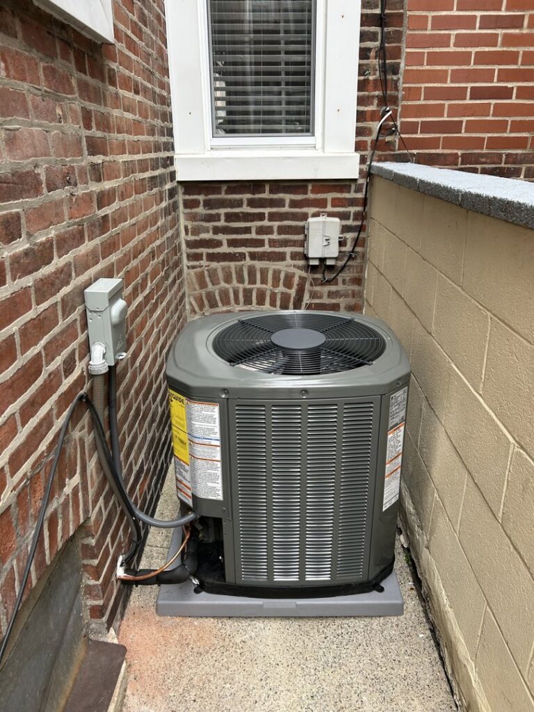 An outdoor AC unit with visible electrical conduit and wiring installed by GEN3 Electric & HVAC in Philadelphia, PA.