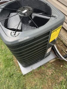 A close-up view of an outdoor air conditioning unit with an EnergyGuide sticker, installed by C&L Heating and Air in Louisville, KY.