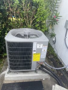 An outdoor air conditioning unit with an EnergyGuide label, installed by J&W Heating and Air + Plumbing in Jacksonville, FL.