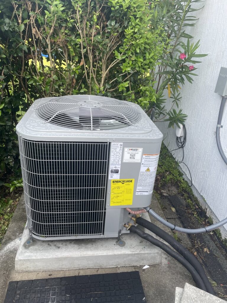 An outdoor air conditioning unit with an EnergyGuide label, installed by J&W Heating and Air + Plumbing in Jacksonville, FL.