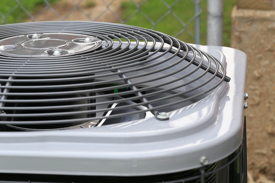 A close-up view of an outdoor air conditioning unit's fan grille, serviced by Basic HVAC in Indianapolis, IN.